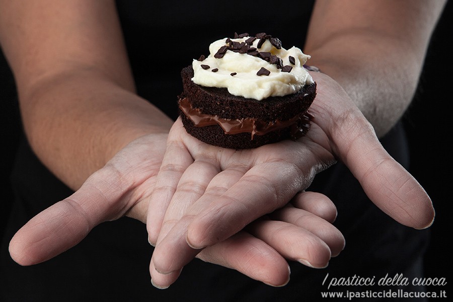 Tortine alla Guinnes ripiene di Nocciolata con glassa al mascarpone e panna tenute in mano